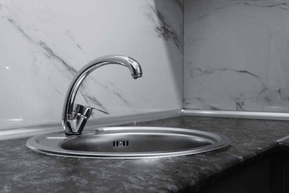 Contractor installing a modern kitchen sink